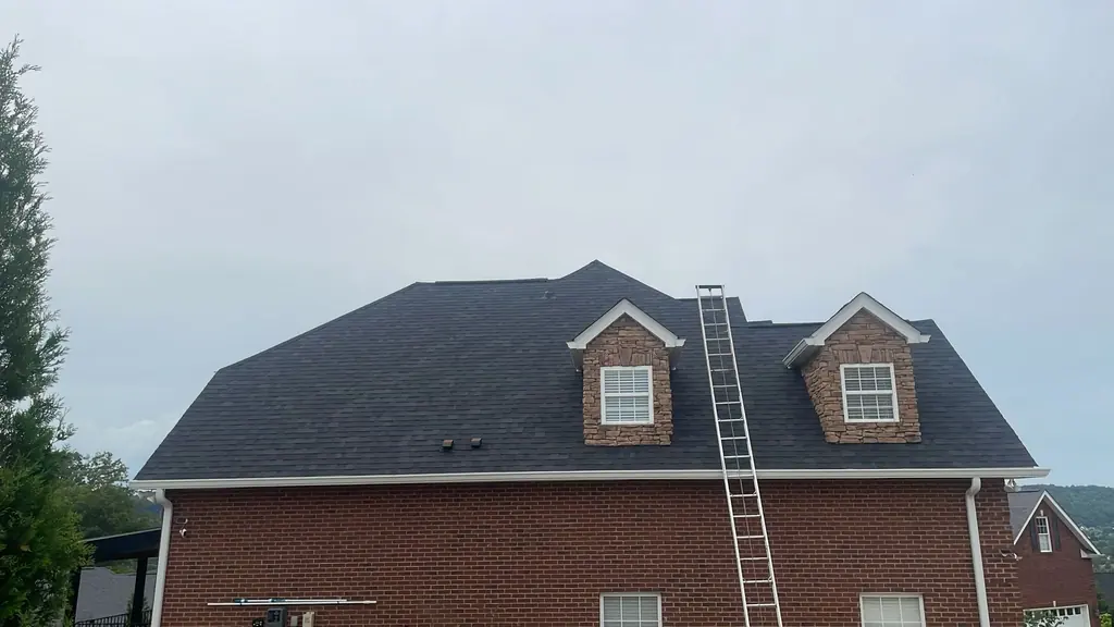 Completed shingle roof with stone dormers on a Knoxville brick home