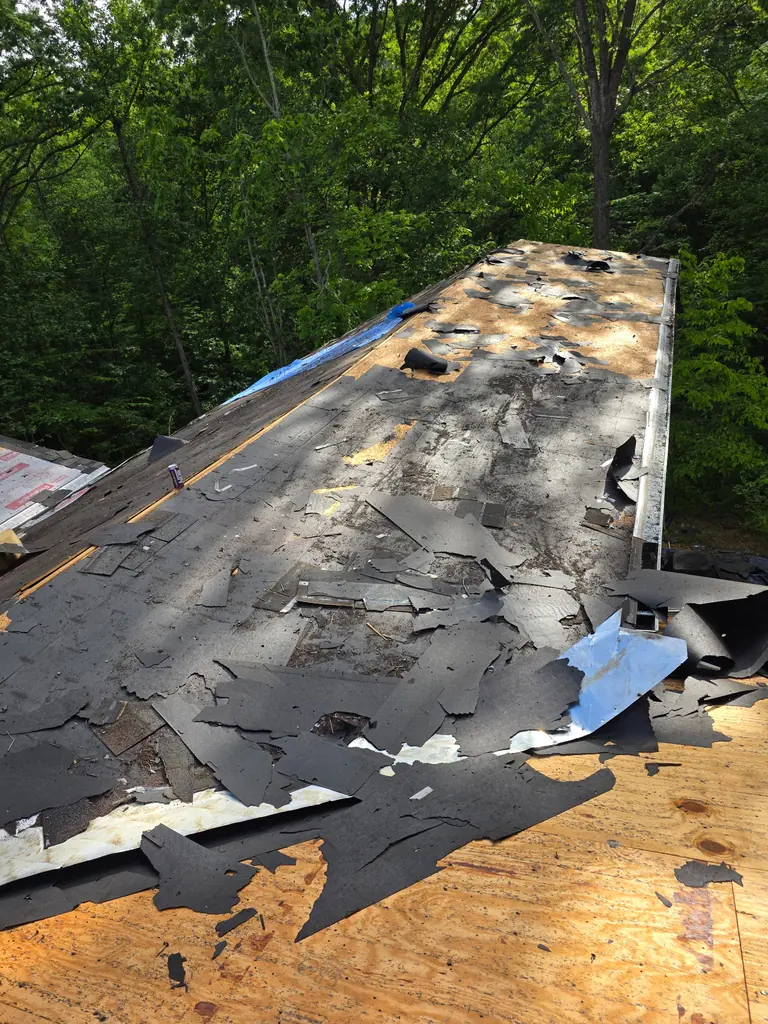 Roofing crew installing shingles on an East Tennessee home
